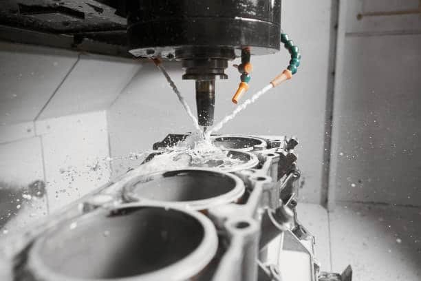 CNC cutting process with coolant spray on aluminum block