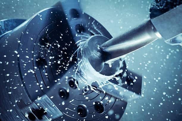 Cutting fluid applied during CNC machining to reduce heat and improve surface finish