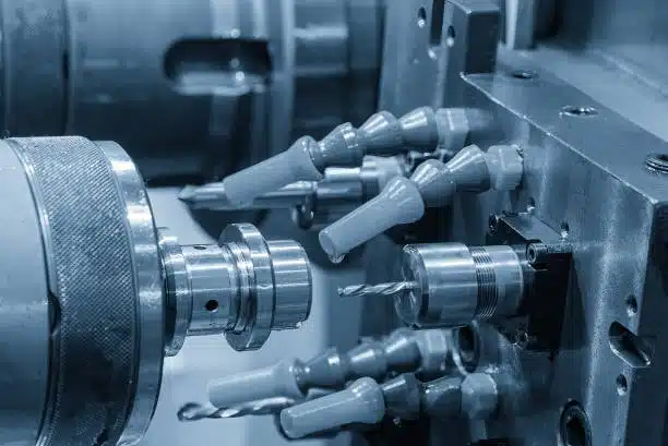 Multiple CNC drill bits arranged in an automatic tool holder system