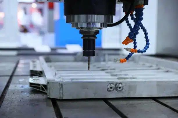 CNC machine setup for drilling operations on an aluminum fixture