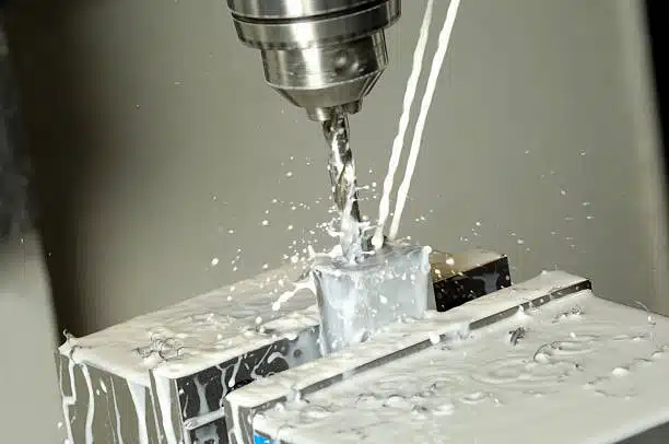 CNC drilling process with coolant applied to the metal workpiece