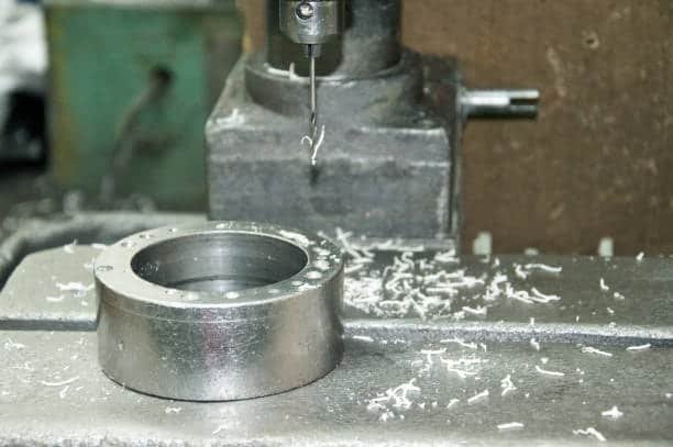 CNC drilling machine processing a metal ring to tight tolerance