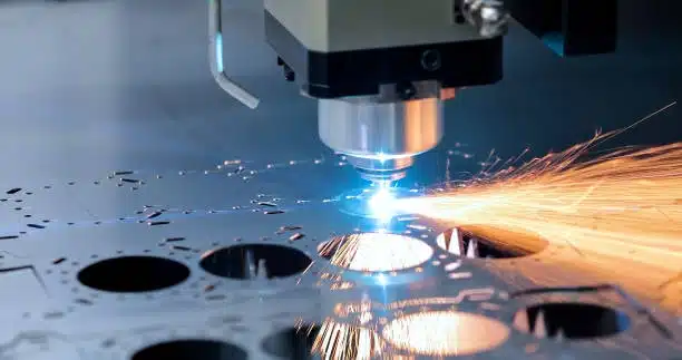 CNC laser cutting machine processing metal sheet with sparks