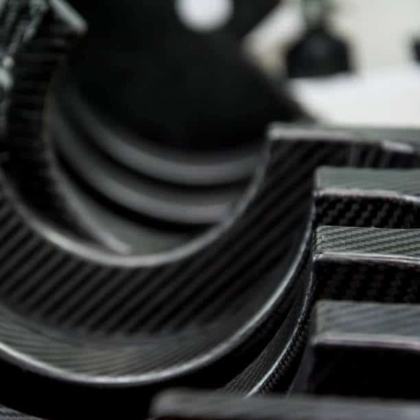Stack of precisely CNC machined carbon fiber components with layered texture