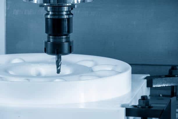 CNC milling machine cutting a plastic workpiece