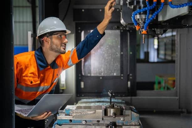 Engineer adjusting CNC milling machine settings