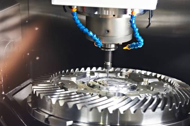 CNC milling machine cutting a precision gear with fine details