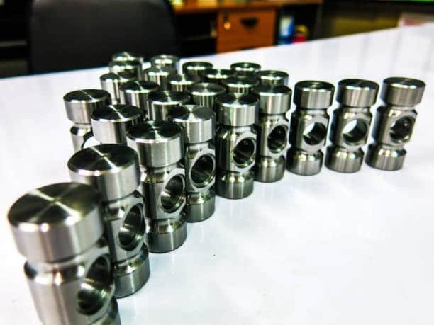 Batch of CNC machined metal components arranged for tolerance verification