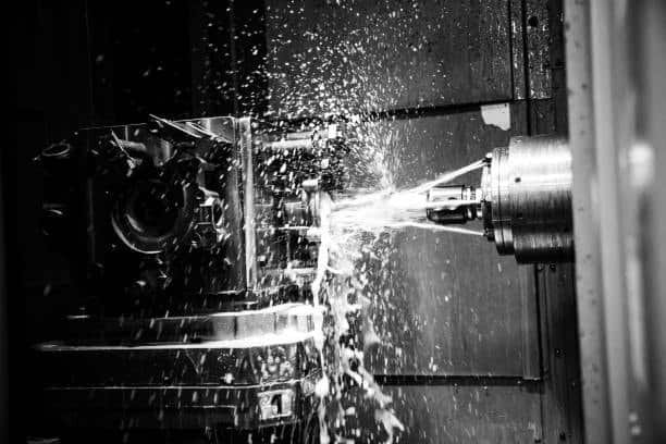 CNC machine creating precision parts with active coolant spray