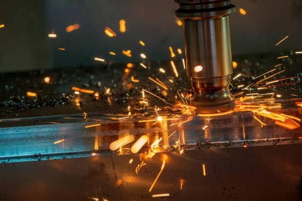 Bright sparks during CNC cutting process illustrating impact of cutting speed