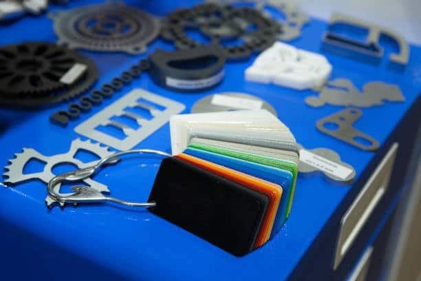 POM Delrin color samples alongside precision-machined plastic components