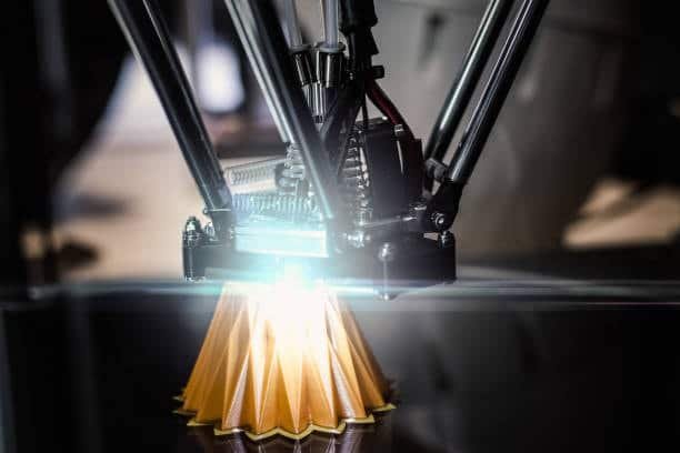 Delta 3D printer creating an orange geometric model