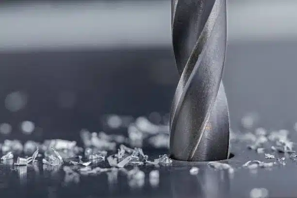 Sharp drill bit with surrounding metal chips after drilling
