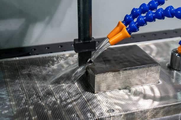 EDM machine flushing coolant during precision machining