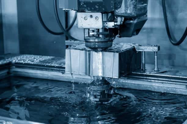 EDM machine performing precision tool setup with water cooling