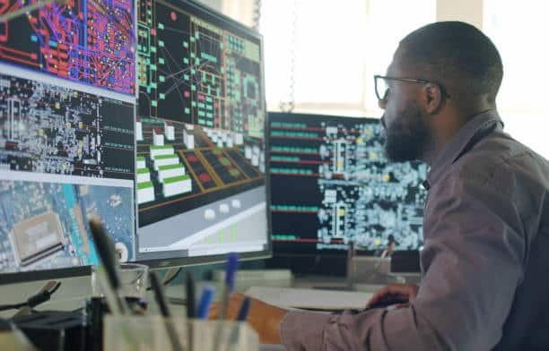 Engineer reviewing electronic system simulation using CAE tools and circuit modeling.