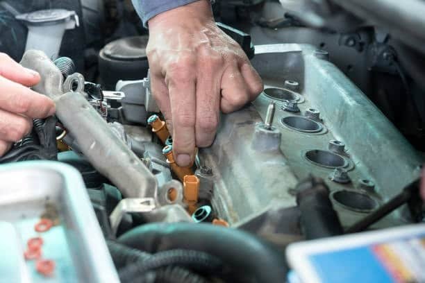 Mechanic working on an engine block using aligned fixture mounts for testing
