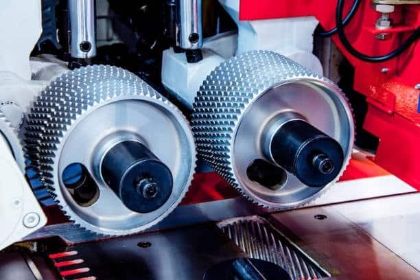 Precision feed rollers used to control feed rate during metal processing