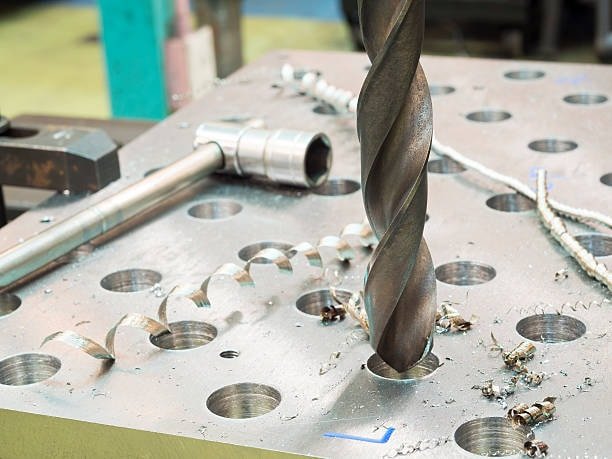 CNC jig and fixture plate with twist drill cutting operation