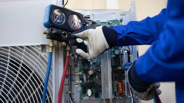 Engineer using digital pressure gauges during machine fixture calibration