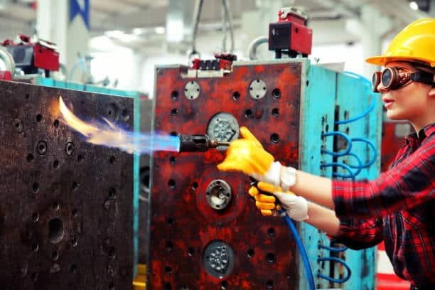 Flame treating an injection mold to prepare for ABS plastic molding