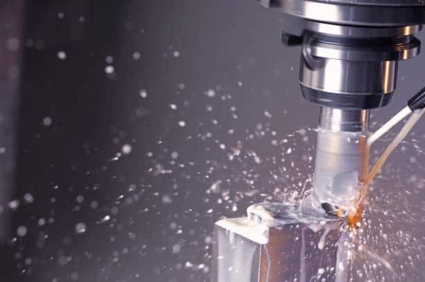 Coolant spraying on metal during CNC milling operation