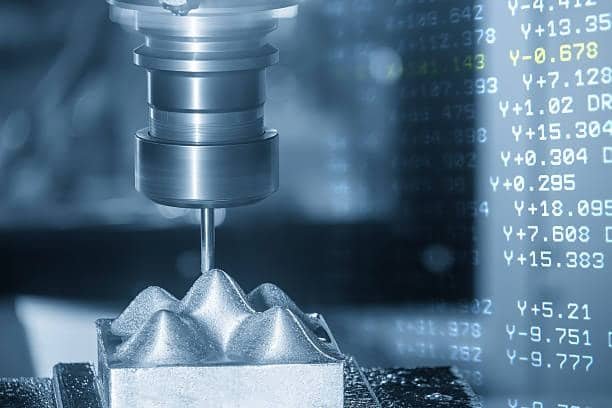 CNC milling machine cutting a patterned metal surface with G-Code coordinate commands overlaid digitally