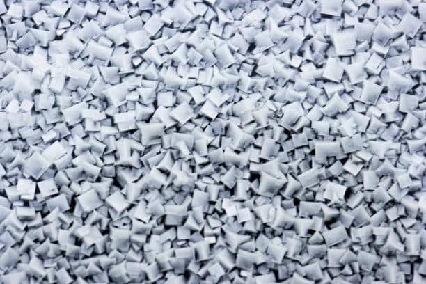 Chopped gray ABS plastic used in injection molding, safe and recyclable.