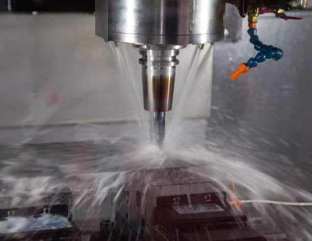 CNC machine using heavy fluid spray during cutting proce
