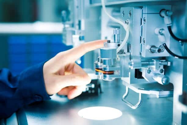 Close-up of high-precision sensor and automated inspection system in operation during manufacturing quality control