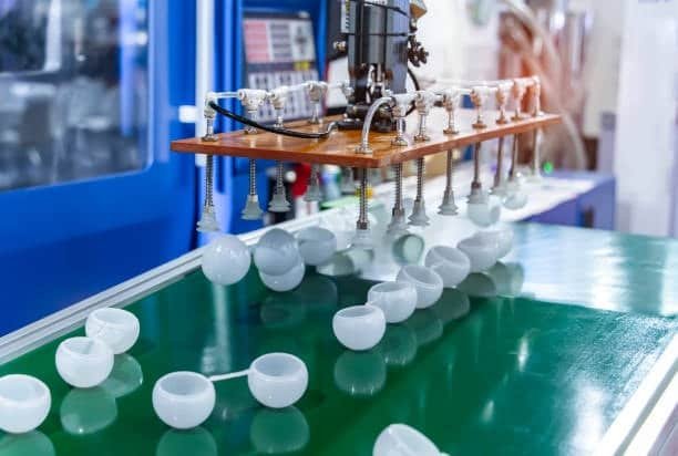 Injection mold with multiple cavities producing low-cost cups.