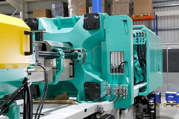 Green injection molding machine optimizing mold production costs.