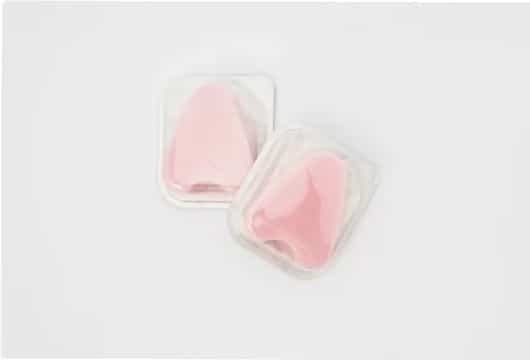Pink liquid silicone rubber (LSR) molded medical parts sealed in blister packaging.