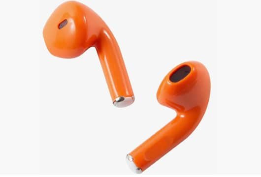 Two injection-molded earbud housings in orange and white, showcasing two-color molding precision.