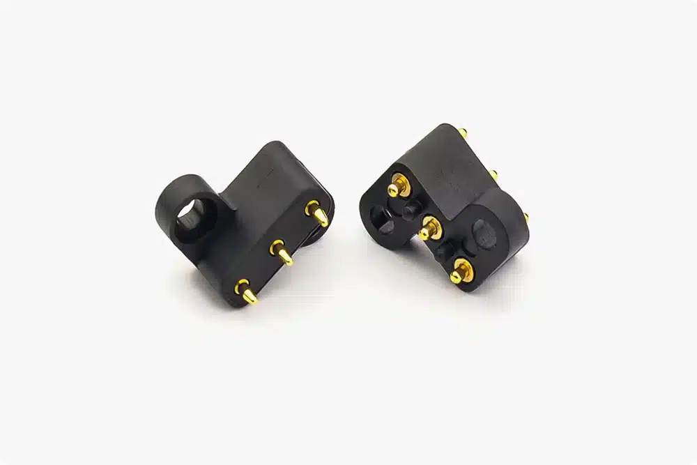 Insert molding part with integrated metal pins and plastic housing, showcasing high precision and durability.