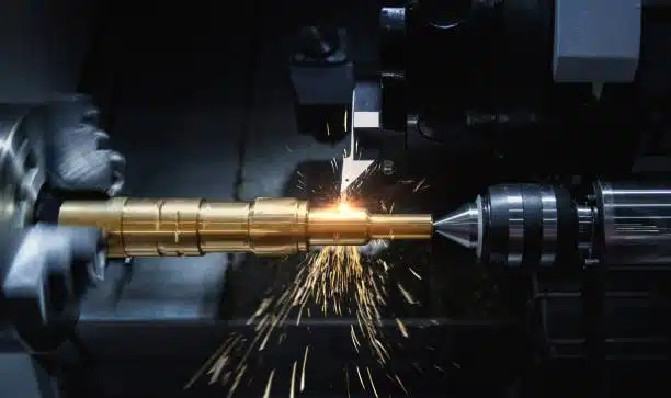 5-axis CNC machine drilling a complex metal component with sparks