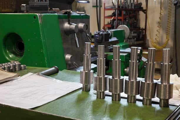 Multiple machined metal shafts arranged for tolerance inspection