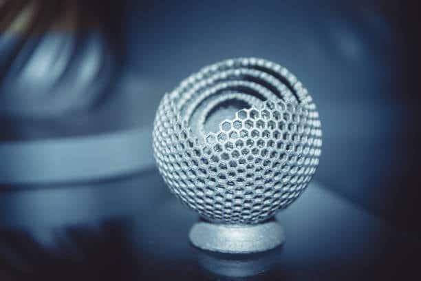 Complex metal part with honeycomb structure created via SLM or DMLS 3D printing process.