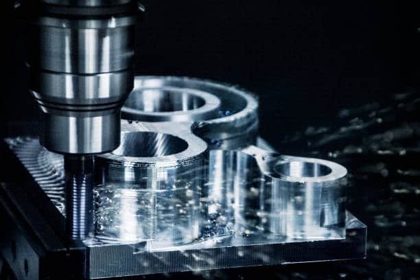 machine drilling metal component