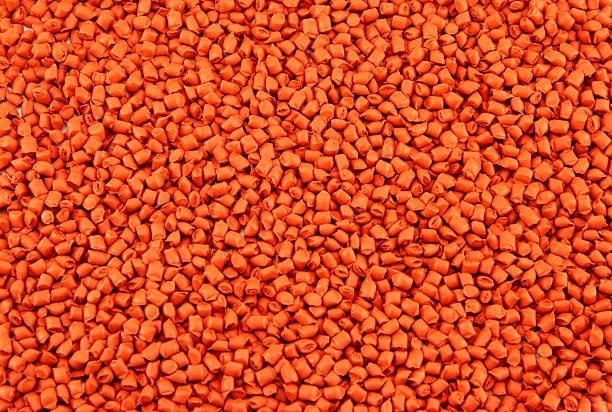 Injection molding design materials including green and orange colored resin granules