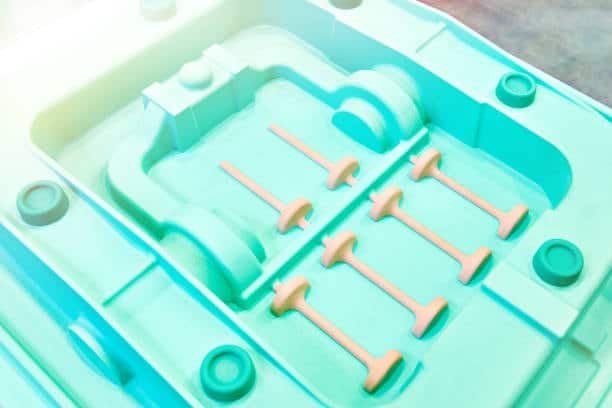 Mold core showing multiple cavity impressions for uniform plastic part production