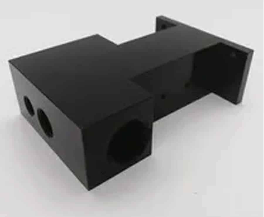 Black CNC-milled plastic component featuring complex geometry and smooth finish