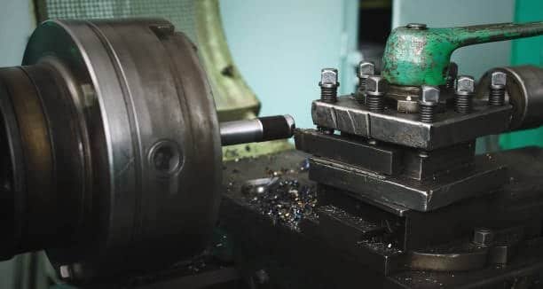 Lathe machine setup with turning insert on a rotating metal rod