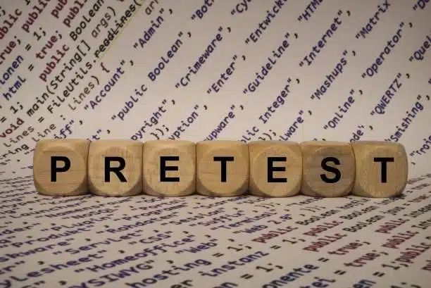 Wooden blocks spelling “PRETEST” over technical terms, symbolizing tolerance verification