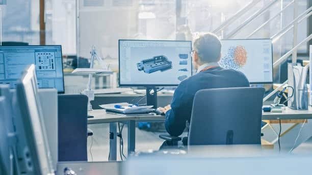 Engineer working with CAE software to simulate product design on screen