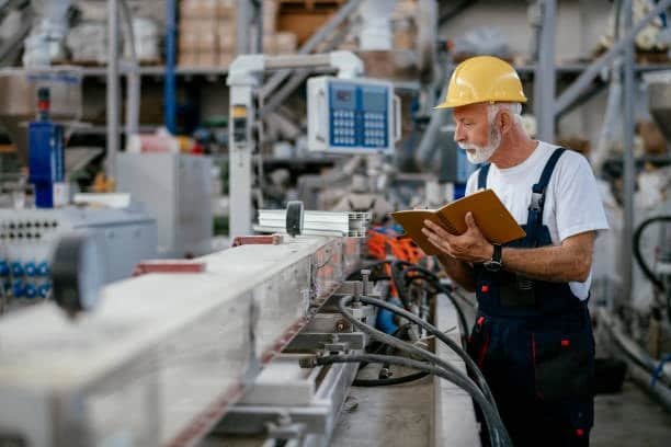 Quality control specialist checking dimensions and tolerances of components on a manufacturing conveyor system