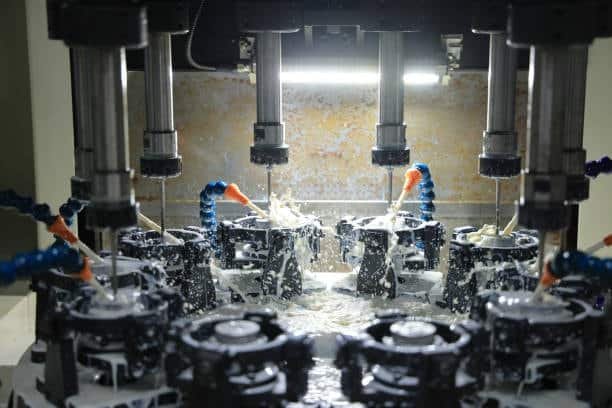 Robotic arm handling injection molds to lower production costs.
