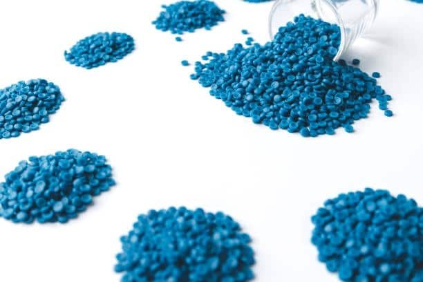 Scattered piles of blue TPE granules showing batch testing and safe formulation.