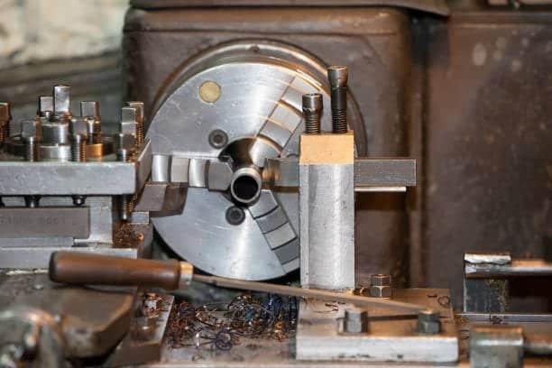 Swiss screw machine lathe with collet and cutting tool in action