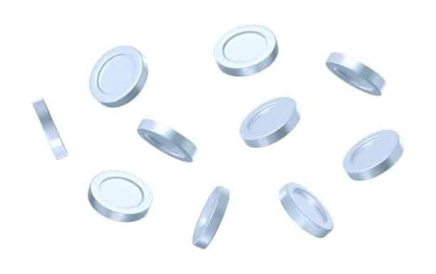 Clear thermoplastic elastomer discs suspended in air, representing safe, latex-free TPE alternatives.
